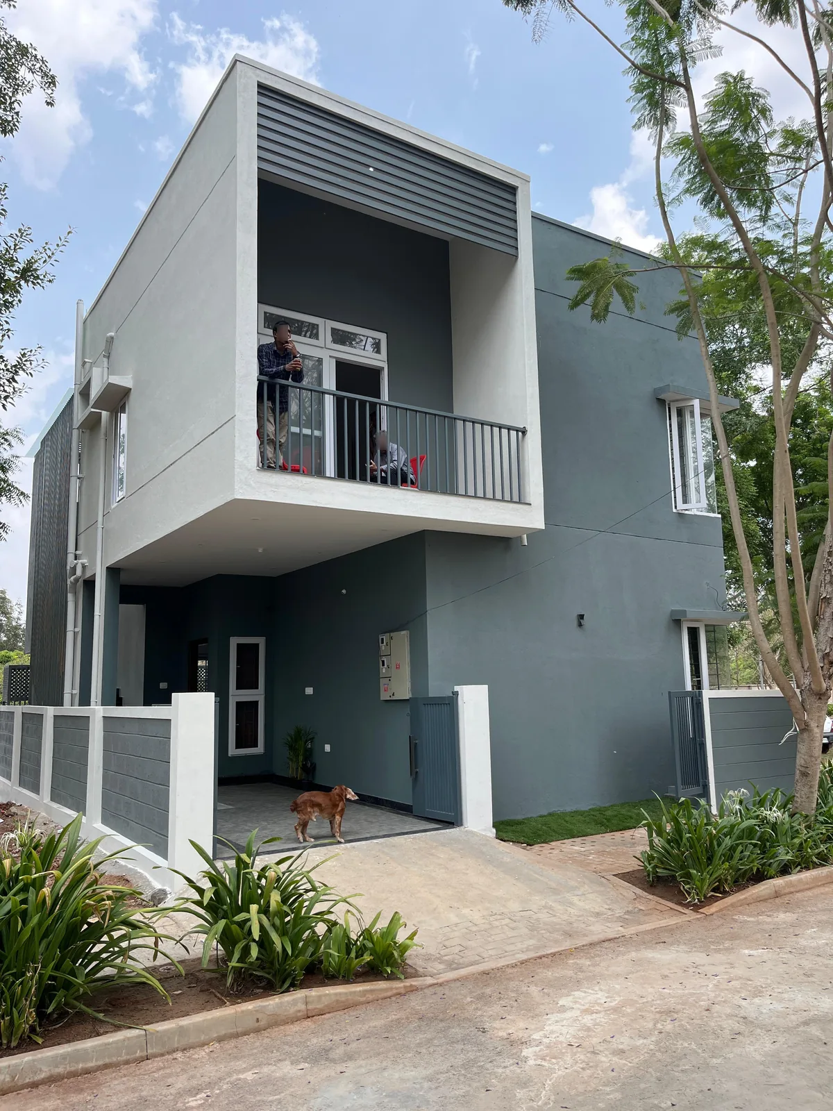 Grey Green Block residence, Mysuru — the completed two-tone house from the street